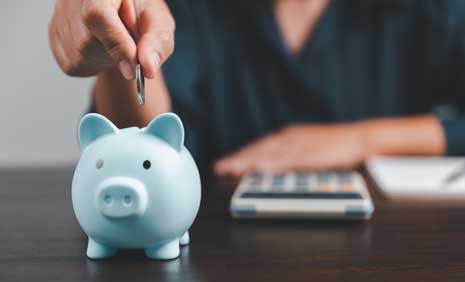 saving-money-by-adding-to-blue-piggy-bank